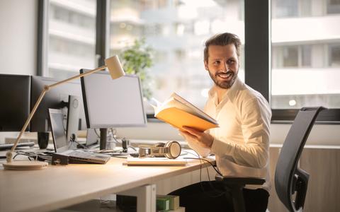 photo_of_man_holding_a_book_927022